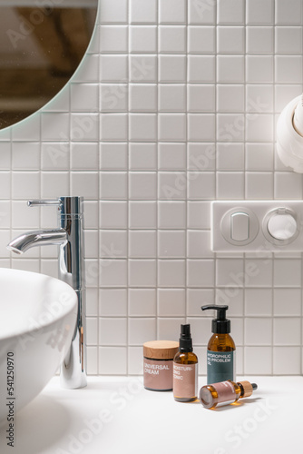 Slika na platnu Cosmetics products in brown recycled glass bottle in bathroom