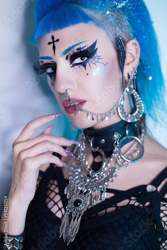 Portrait of a goth girl with blue hair and makeup
