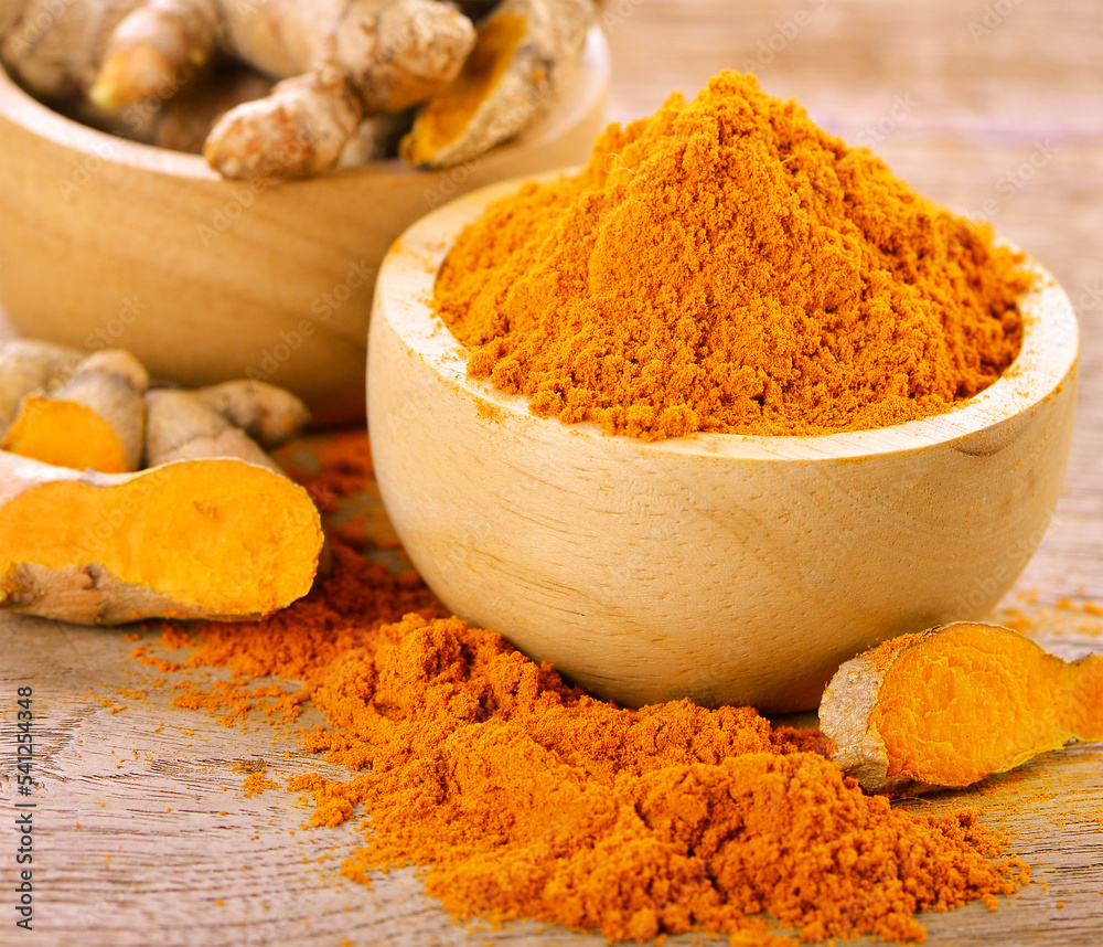 turmeric powder in spoon on wood. This herb high vitamin C. Vitamin c for protect virus. turmeric powder in spoon on wood. This herb high vitamin C. Vitamin c for protect virus.