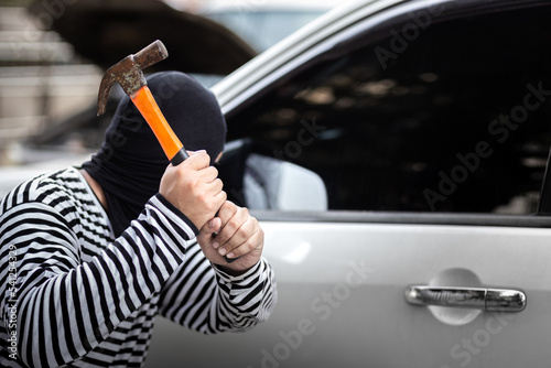 Foto Car thief hijack and steal or rob money in car and car breaking door window with