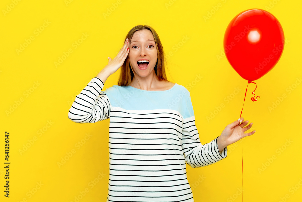 Young funny woman in party cone celebrates birthday or special occasion. Holiday and party concept. Colorful studio portrait with yellow background Young funny woman in party cone celebrates birthday or special occasion. Holiday and party concept. Colorful studio portrait with yellow background