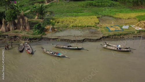 Munsiganj, Bangladesh - 24 October 2022: Aerial view of people working along the river on wooden boats. photo