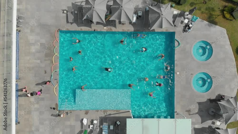 People having fun in the pool. water gymnastics People having fun in the pool. water gymnastics