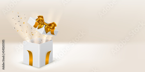 Festive illustration with open white gift box with golden ribbons and bow. Pieces of serpentine and rays of light fly out of it