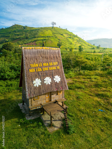 Aerial view of Chu Dang Ya volcano mountain and nha rong house, text on this house mean Da Quy flower festival, near Pleiku city, Gia Lai province, Vietnam photo