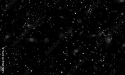 Abstract real dust particle flow in the air on black background