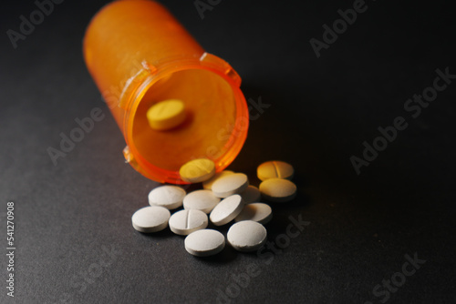 opioid medical pills spilling on black background  photo