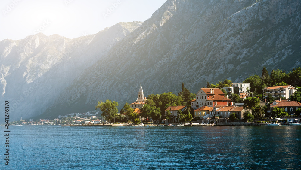 Ancient city with old buildings in Montenegro, view from Adriatic sea. Beautiful town with mountains and amazing nature
