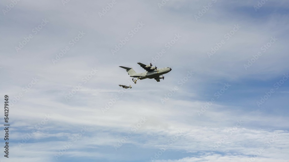ZM409 RAF Royal Air Force Airbus A400M Atlas military cargo airplane on a low level run drops several large containers by parachute ZM409 RAF Royal Air Force Airbus A400M Atlas military cargo airplane on a low level run drops several large containers by parachute