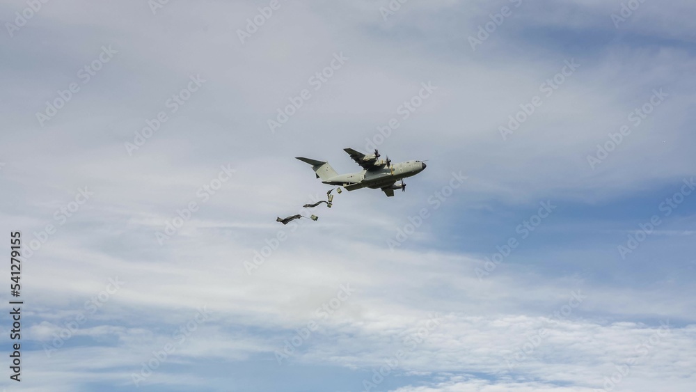 Royal Air Force Airbus A400M Atlas military cargo airplane (RAF ZM409) on a low level run drops several large containers by parachute Royal Air Force Airbus A400M Atlas military cargo airplane (RAF ZM409) on a low level run drops several large containers by parachute