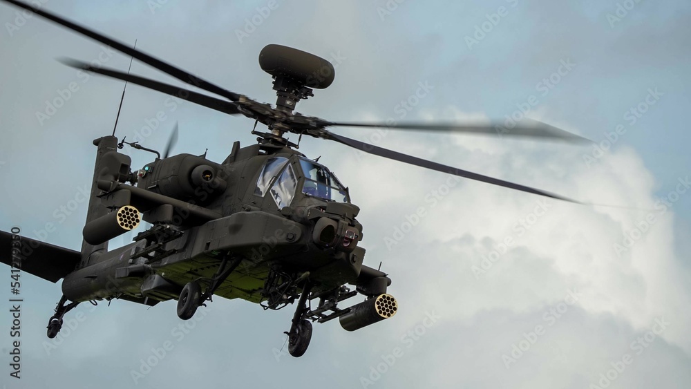 close-up front quarter view of ZM707 British army Boeing Apache Attack helicopter gunship (AH64E AH-64E ArmyAir606) in low level flight 