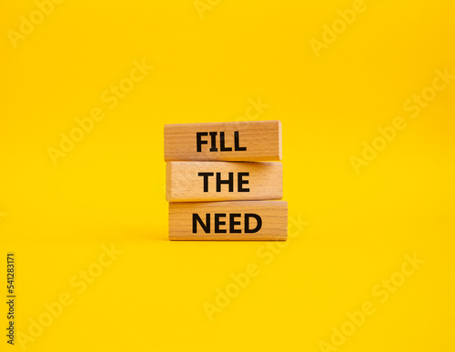 Fill the need symbol. Concept word Fill the need on wooden blocks. Beautiful yellow background. Business and Fill the need concept. Copy space