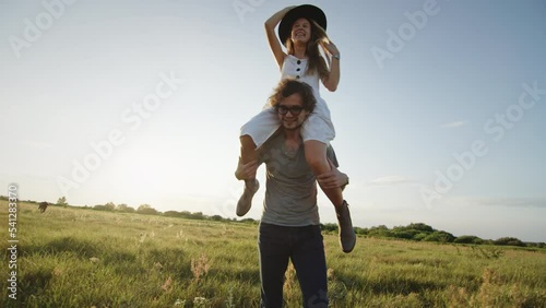 Man carrying woman on shoulders