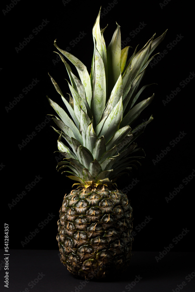 Obraz premium Pineapple on a black background. Tropical Fruit