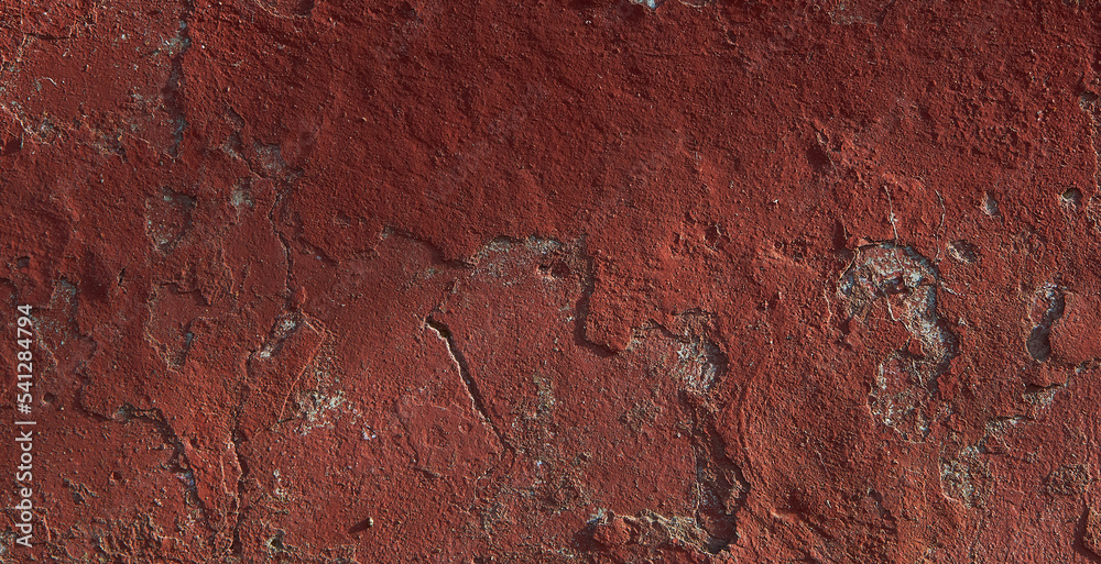 Fototapeta premium Texture of old red paint on the wall of the building