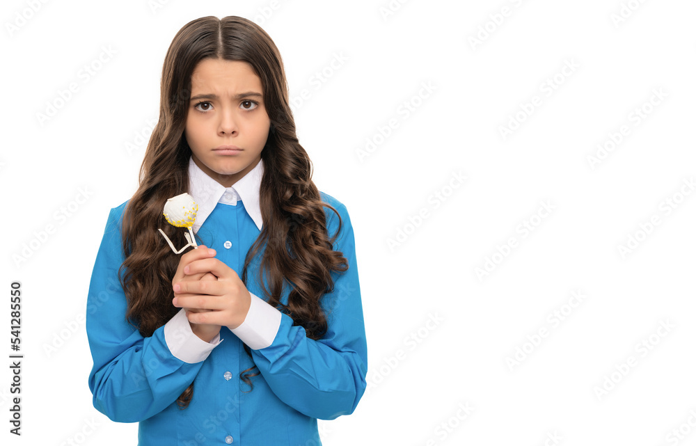 sad child with chocolate. kid with long curly hair hold stick sweet. sugar candy on stick. sad child with chocolate. kid with long curly hair hold stick sweet. sugar candy on stick.
