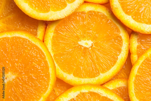 Fresh orange fruit slices background, close up