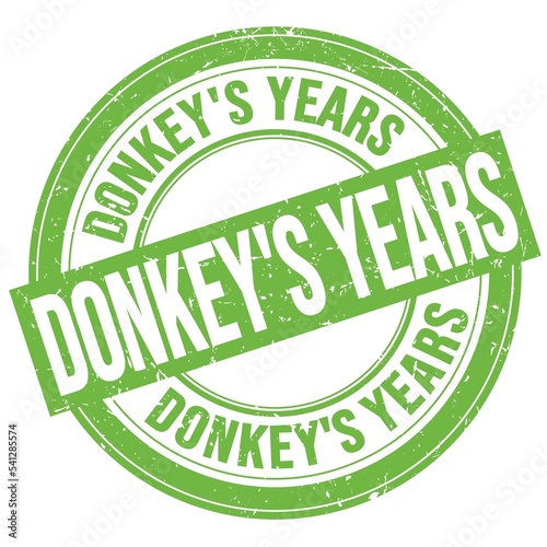 DONKEY'S YEARS text written on green round stamp sign