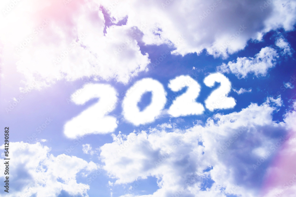 Text caption 2022 in clouds. Cloud-style text in sunny glare.