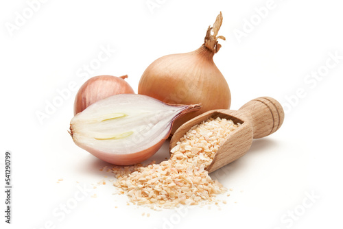 Dried onion on a wooden spatula, surrounded by whole onion and garlic © piotrszczepanek