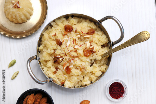 Rava Sheera or Suji ka halwa, shira is an indian sweet dish, made with semolina, sugar, ghee and dry fruits. served as dessert or as Prasad during festivals. Garnished with saffron. Copy space. photo