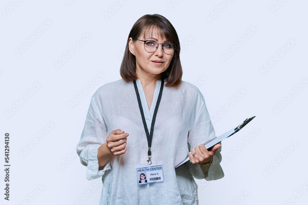 Female medical center worker with clipboard badge on white background Female medical center worker with clipboard badge on white background
