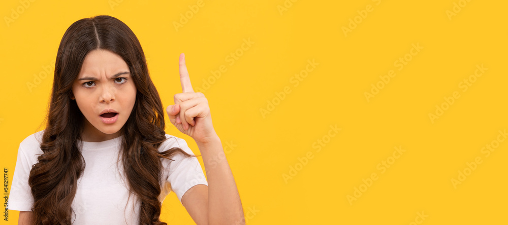 serious kid hold retro alarm clock showing time with raised finger, discipline. Child face, horizontal poster, teenager girl isolated portrait, banner with copy space. serious kid hold retro alarm clock showing time with raised finger, discipline. Child face, horizontal poster, teenager girl isolated portrait, banner with copy space.
