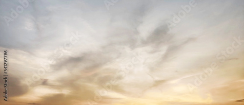 Beautiful sunset sky, the sun leaving bright golden shades background with clouds in sunny day. wallpaper background.