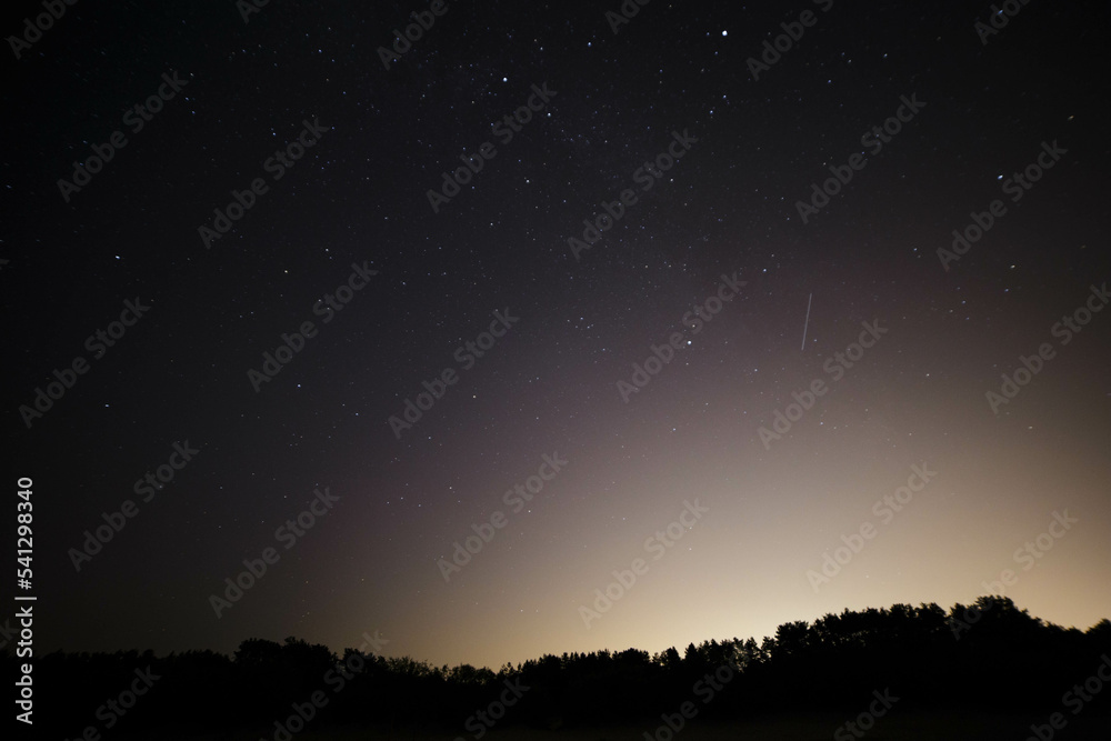 Deep night sky with many stars and forest and sea Deep night sky with many stars and forest and sea