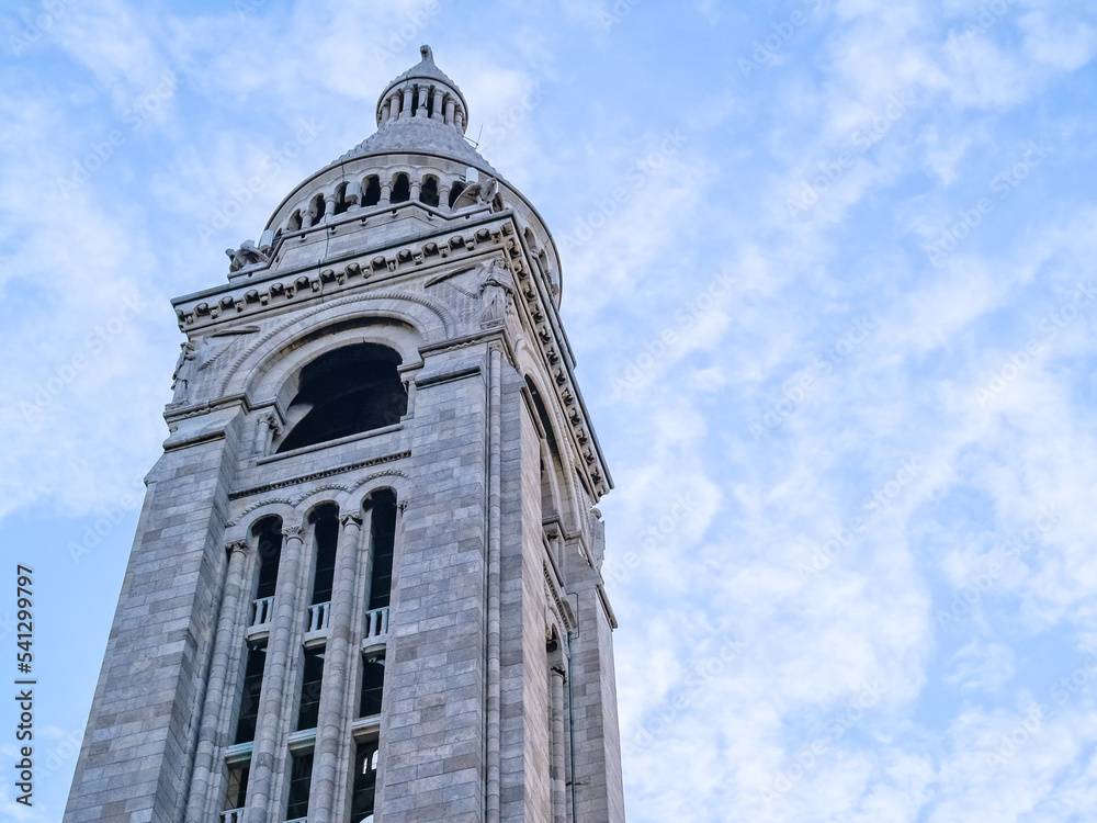 Tall tower against blue cloudy sky