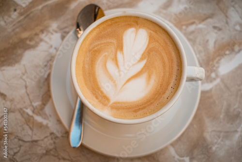 Print op canvas latte art milk coffee top view.  caffeine drink on marble table .