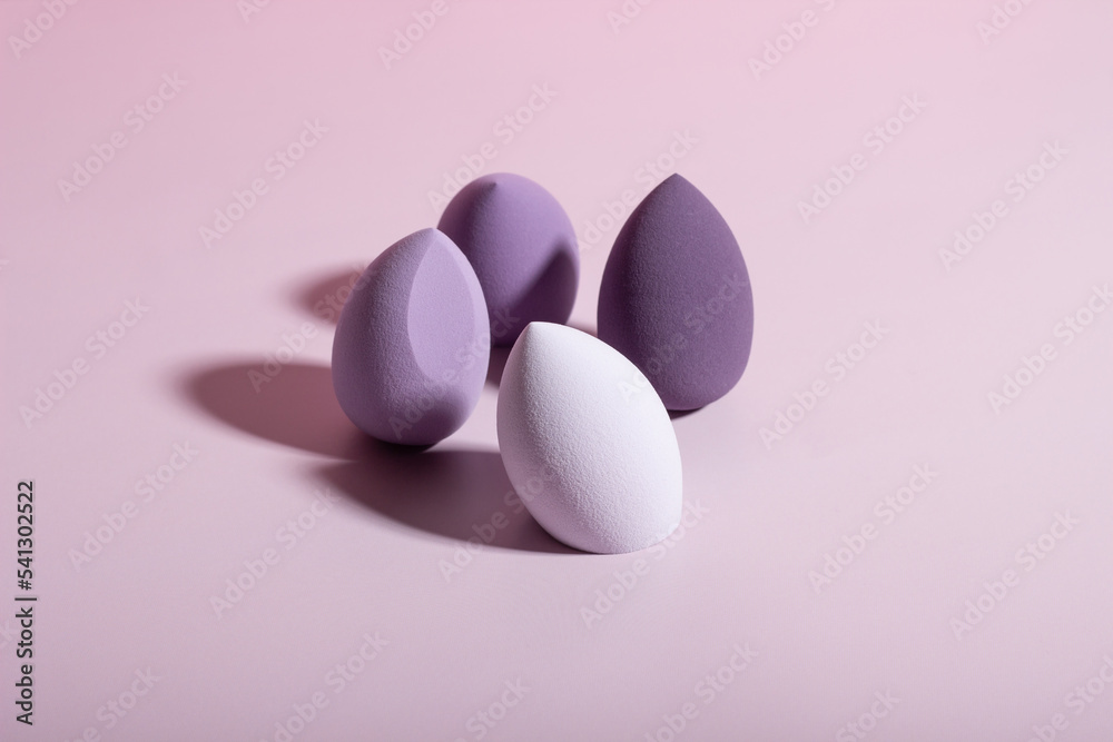 Purple make-up sponges. Concept of beauty, makeup and beauty salon Purple make-up sponges. Concept of beauty, makeup and beauty salon