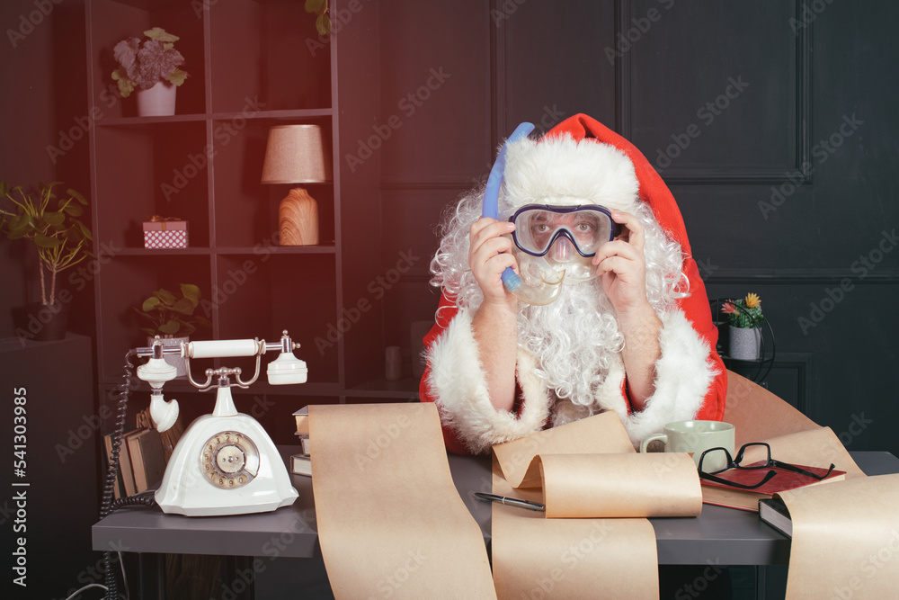 Funny fat Santa Claus is sitting in the office bombarded with lists
