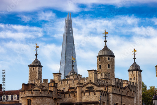 Historic Brick Building, Tower of London, in a modern city during cloudy blue sky morning. London, United Kingdom. Travel Destination