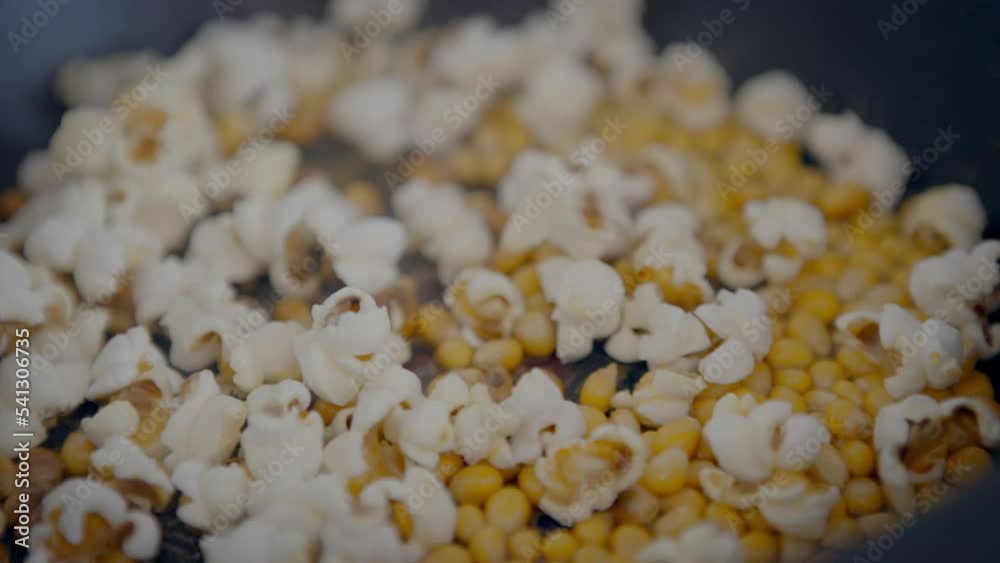Slowmotion of homemade popcorn popping wildly from a frypan. Crunchy pop corn snack in cooked a pan. delicious and tasty corns kernels almost popped with salt Slowmotion of homemade popcorn popping wildly from a frypan. Crunchy pop corn snack in cooked a pan. delicious and tasty corns kernels almost popped with salt