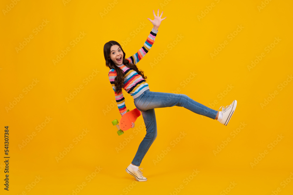 Teen hipster girl skater with skateboard on isolated background. Summer kids trend, urban teenage style. Happy teenager, positive and smiling emotions of teen girl.