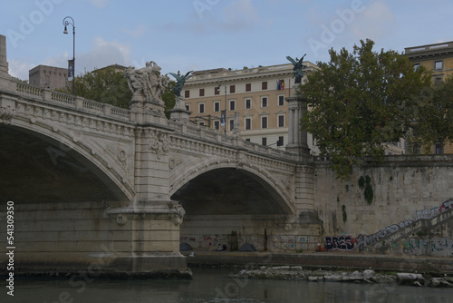 A view of the Saint Angelo bridge during the fall spanning the Tiber river in Rome Italy.