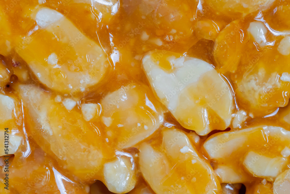 Top view: caramelized nuts fried in honey - Gozinaki - orange granola peanut bar - close up, macro. Traditional Georgian cuisine, oriental sweet, gastronomy and food concept Top view: caramelized nuts fried in honey - Gozinaki - orange granola peanut bar - close up, macro. Traditional Georgian cuisine, oriental sweet, gastronomy and food concept