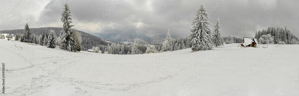 view of beautiful fabulous house of covered in snow. winter landscape with mountains. view of beautiful fabulous house of covered in snow. winter landscape with mountains.