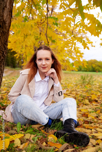Portrait of beautiful young girl in autumn park