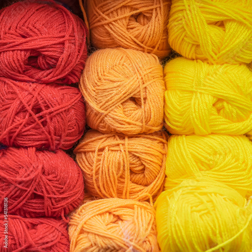 Skeins of multicolored, bright woolen threads, yarn for knitting close-up