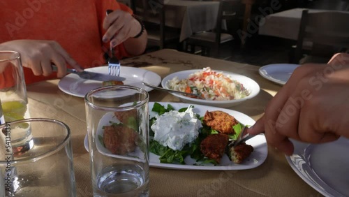 Eating greek food in a Greek tavern in Nymfaio, Greece. photo