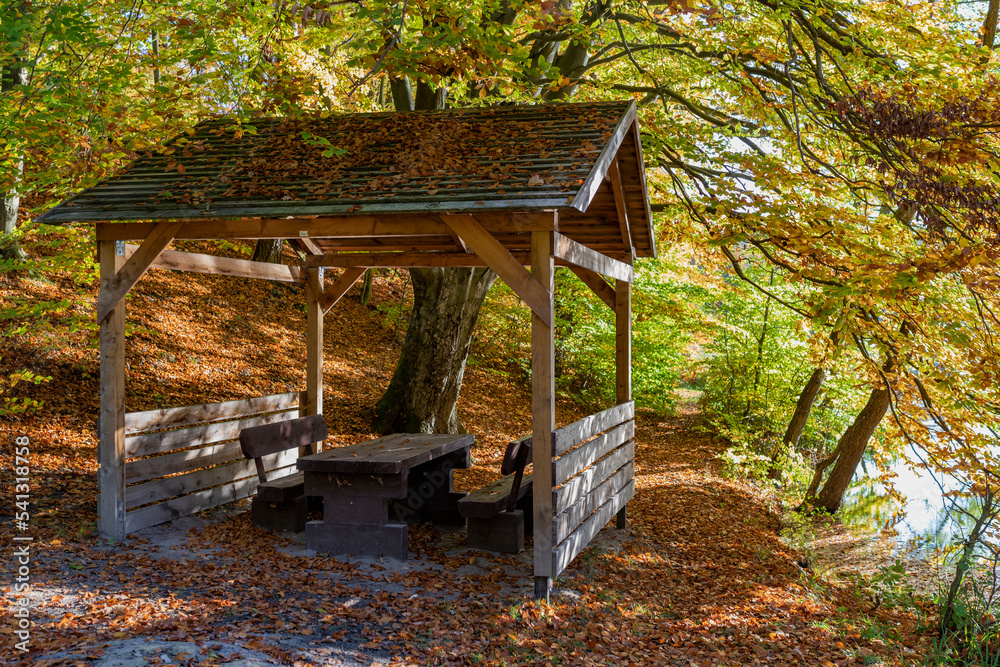 A wooden house in the forest for relaxing on the trail. A clear and sunny autumn day. A wooden house in the forest for relaxing on the trail. A clear and sunny autumn day.