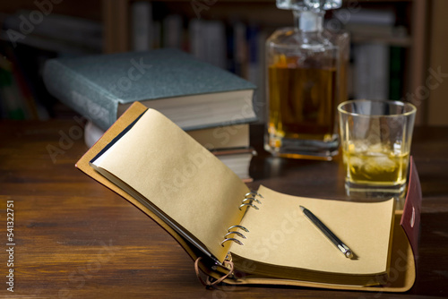 Ready to write, a glass of whiskey and some books