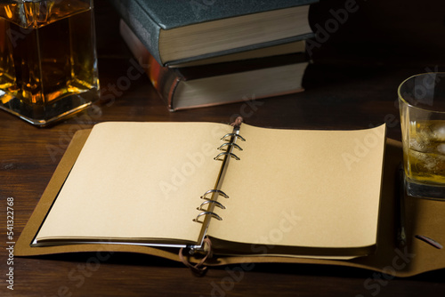Ready to write, a glass of whiskey and some books