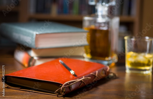 Ready to write, a glass of whiskey and some books