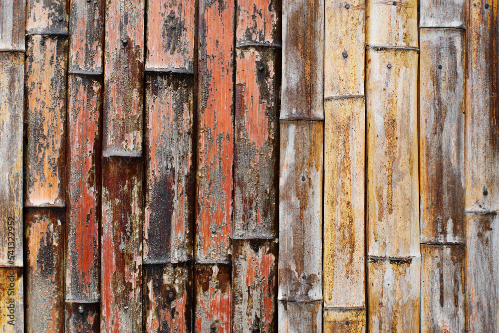 Rough texture background from bamboo stalks. The use of bamboo trunks in construction, decor, wall decoration Rough texture background from bamboo stalks. The use of bamboo trunks in construction, decor, wall decoration