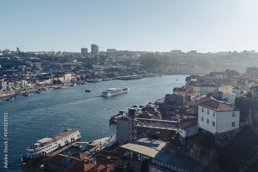 Douro river view scene crossing Oporto city on a blue summer day with some tourist boats cityscape