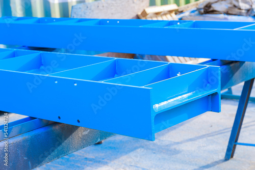 Industrial work. Metal products painted with a compressor gun dry on a sawhorse.