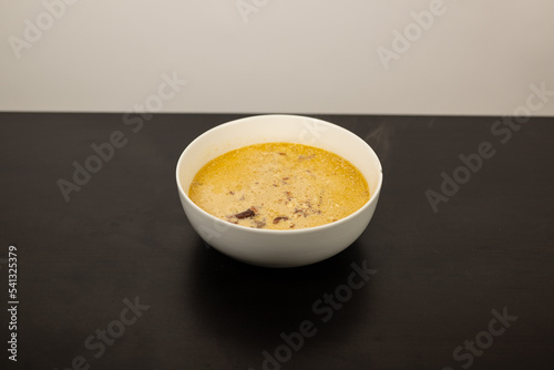 Cheese Burger Soup with ground beef cheese and a white bowl photo